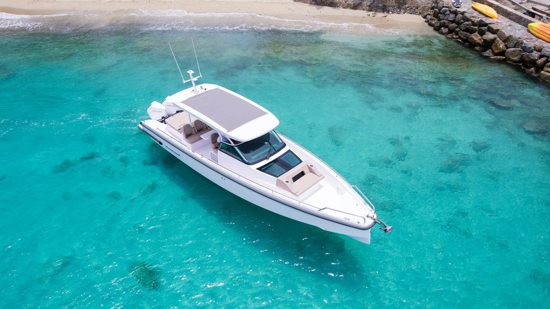 Private boat anchored in clear shallow water